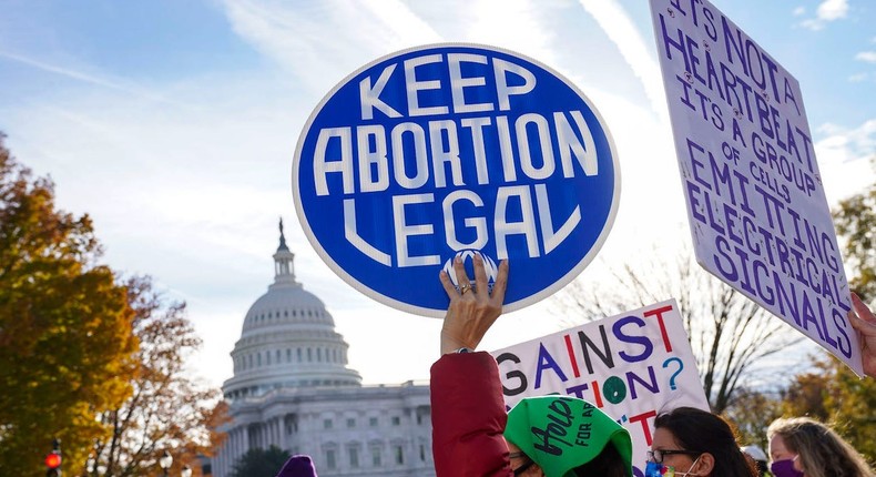 Participants hold signs during the Women's March at the US Supreme Court.