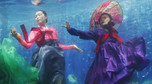 A promoter wearing a traditional hanbok performs in a water tank at the "Underwater Hanbok Fashion Show" during a photo call in Seoul