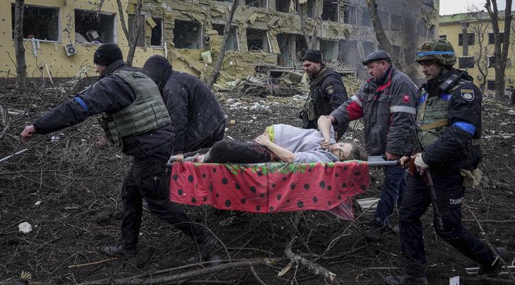 Szülőotthonba visznek egy sebesült asszonyt a dél-ukrajnai Mariupolban 2022. március 9-én. 