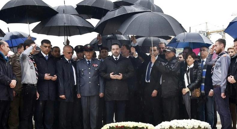 Lebanese Prime Minister Saad Hariri (C) prays over the tomb of his father, slain former prime minister Rafiq Hariri, in Beirut on February 14, 2017