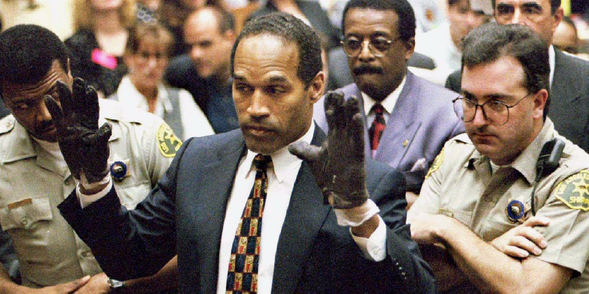 O.J. Simpson holds up his hands to the jury.