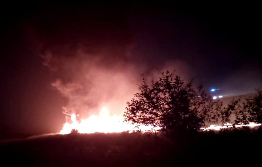 A plume of smoke rises from flames after an Utair Boeing 737 passenger plane made a rough landing an