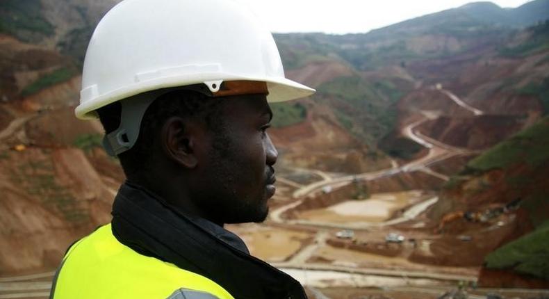 An employee stands in an open pit at Banro's Twangiza mine in eastern Congo, September 28, 2011. REUTERS/Tom Kirkwood