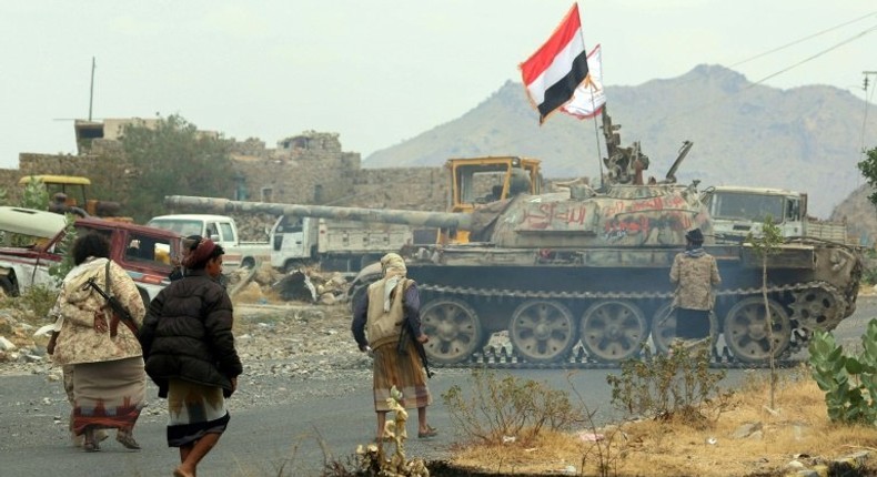 Yemeni fighters loyal to Yemen's exiled President Abedrabbo Mansour Hadi, drive a tank during clashes with Shiite Huthi rebels in the country's third-city of Taez on December 19, 2016