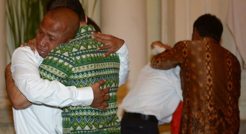 Elson Pesireron (L) hugs his brother Sammy as he and other freed Indonesian sailors held hostage for nearly five years by Somali pirates reunite with family members at the Foreign Ministry office in Jakarta on October 31, 2016