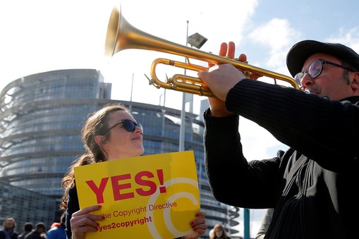 Demonstrators take part in a protest in front of the European Parliament as MEPs debate on modificat