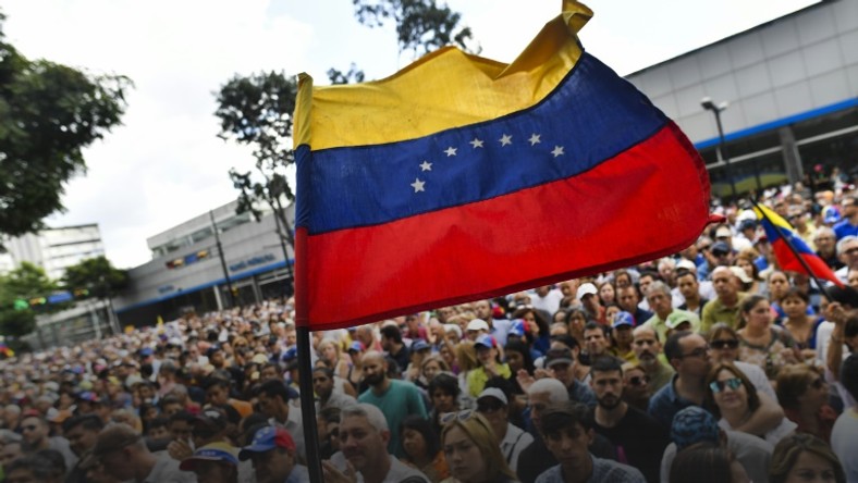 Anti-government activists listen to the president of Venezuela's opposition-led National Assembly Juan Guaido in Caracas on January 11, 2019