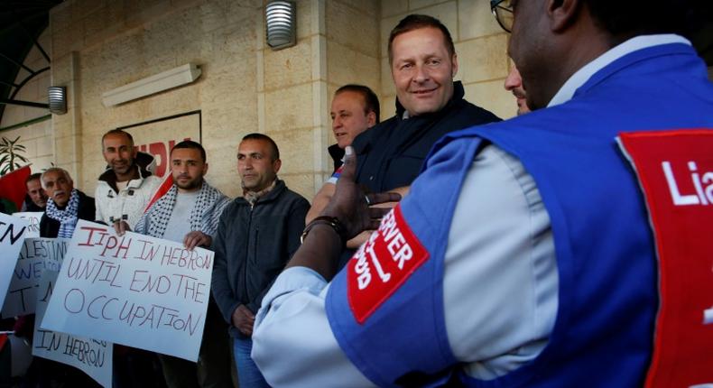 Members of the Temporary International Presence in Hebron (TIPH), pictured here with activists in January 2019, established the group following a massacre of Palestinians in 1994