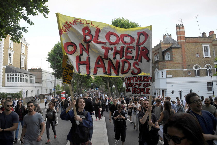 Demonstrators confront a man they believe to be Robert Black, the Chief Executive of KCTMO, outside 