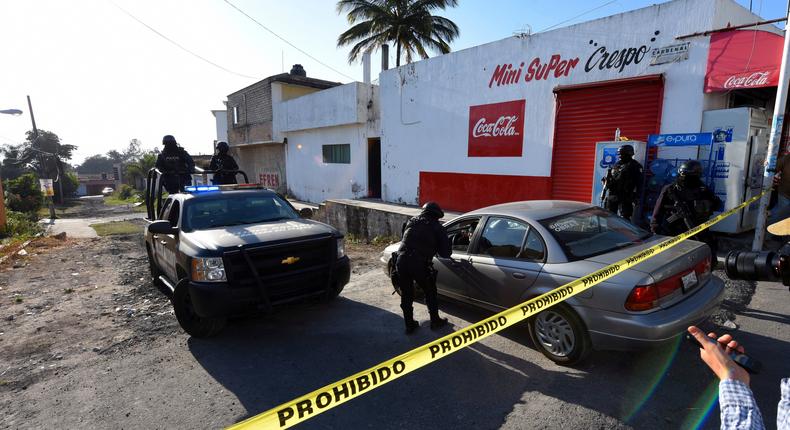 Police guard an area after a gun battle in which a suspect identified by authorities as the leader of the Beltran Leyva cartel was killed, Nayarit, Mexico, February 10, 2017.