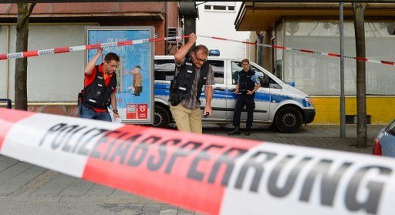 Police officers investigate the site of an attack