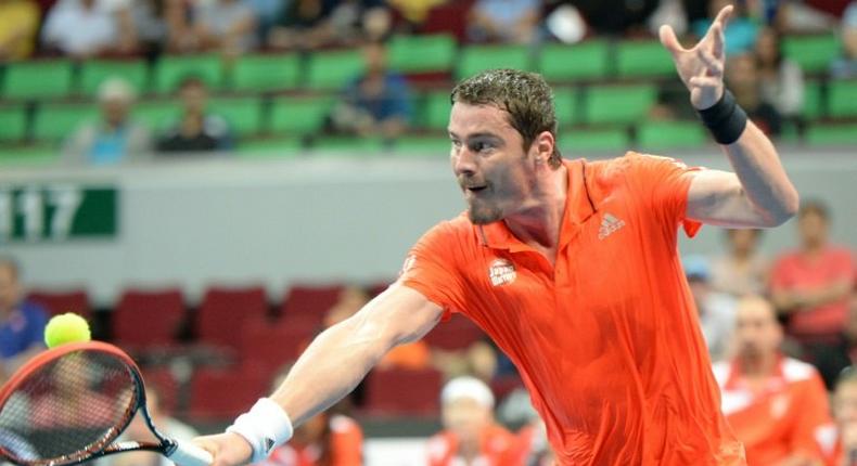 Russia's Marat Safin of the Japan Warriors hits a return against Spain's Carlos Moya of the Singapore Slammers during their men's singles match at the International Premier Tennis League in Manila on December 6, 2015