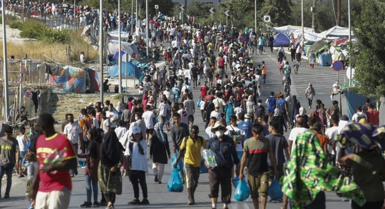 Hundreds of migrants have reluctantly made their way to the new site in the searing heat