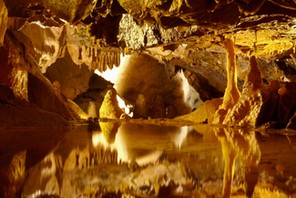 Stalactites and stalagmites reflected in pool, Gough's Cave, Cheddar Caves, Somerset, England, UK