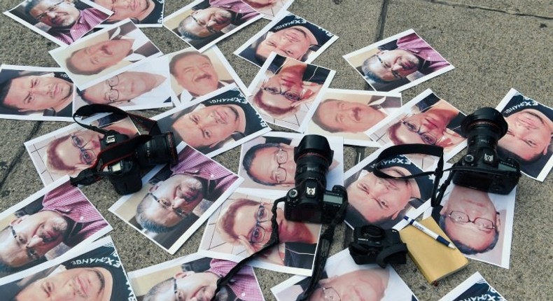 Pictures of journalists recently murdered in different Mexican states lay on the ground at Independence Angel square during a protest by journalists in Mexico City, on May 16, 2017