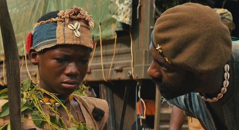 A scene from the movie [Abraham Attah and Idris Elba]