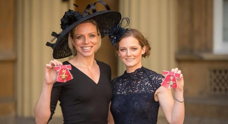 Former Great Britain hockey captain Kate Richardson-Walsh (L) and her wife Helen pose at Buckingham Palace in London after the investiture ceremony where they received an OBE and MBE respectively on February 17, 2017