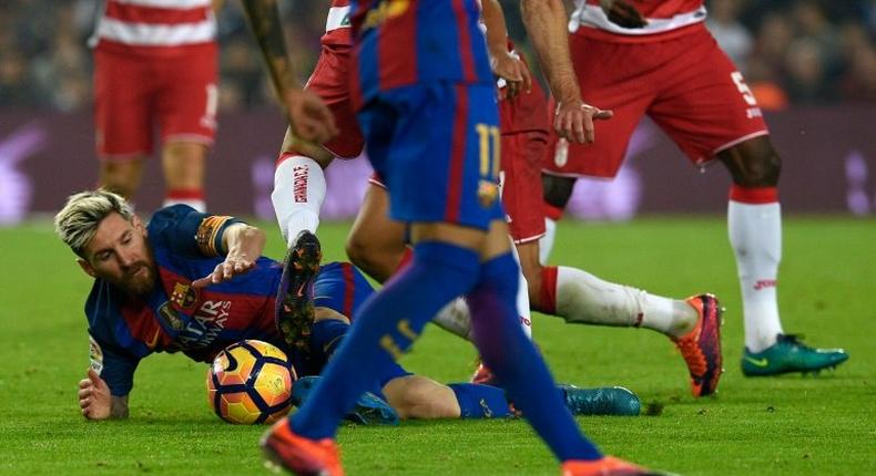 Barcelona's Argentinian forward Lionel Messi fights for the ball on the field during the Spanish league football match between FC Barcelona and Granada FC at the Camp Nou stadium in Barcelona on October 29, 2016