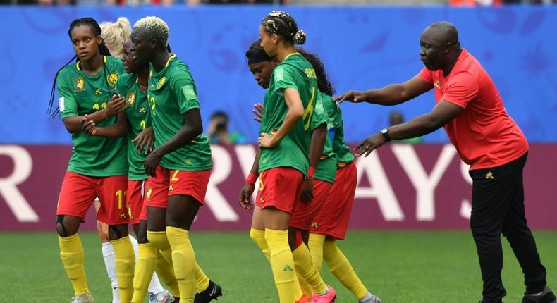 Cameroon coach Alain Djeumfa (R) said his players remained 'very professional' throughout their bad-tempered 3-0 defeat against England on Sunday