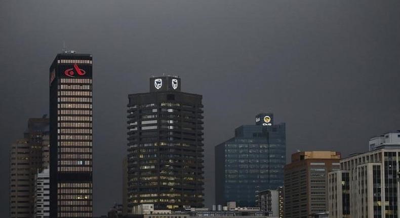 The logos of South Africa's three biggest banks, ABSA, Standard Bank and First National Bank (L-R), adorn buildings as winter storms hit Cape Town, July 8, 2015.  REUTERS/Mike Hutchings