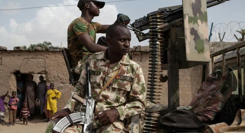 Nigerian soldiers on patrol in Banki, Borno State, to guard against infiltration or attack by Boko Haram insurgents