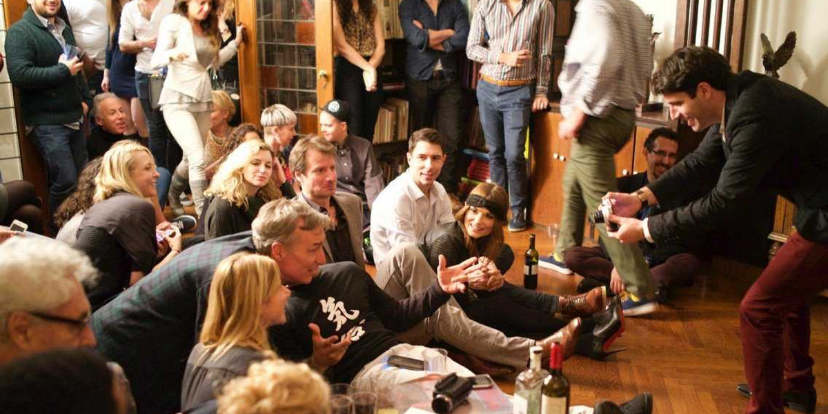 Jon Levy snaps a photo of Bill Nye and other guests at a salon held in his Manhattan apartment.