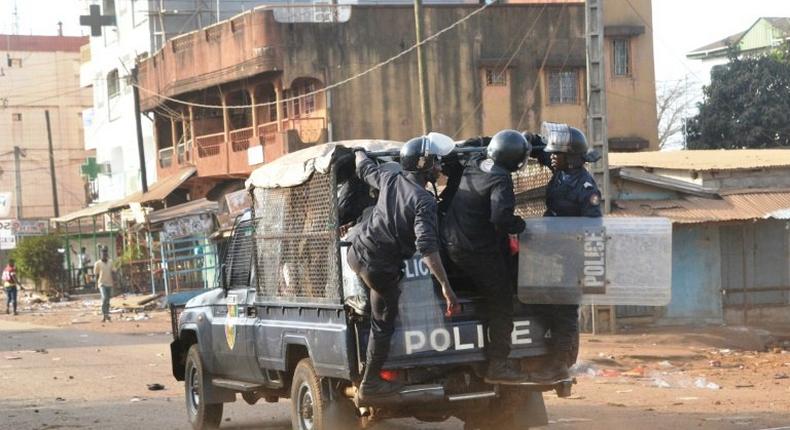 Policemen stand on a vehicle during a protest of teachers asking for wage increase on February 20, 2017 in Conakry