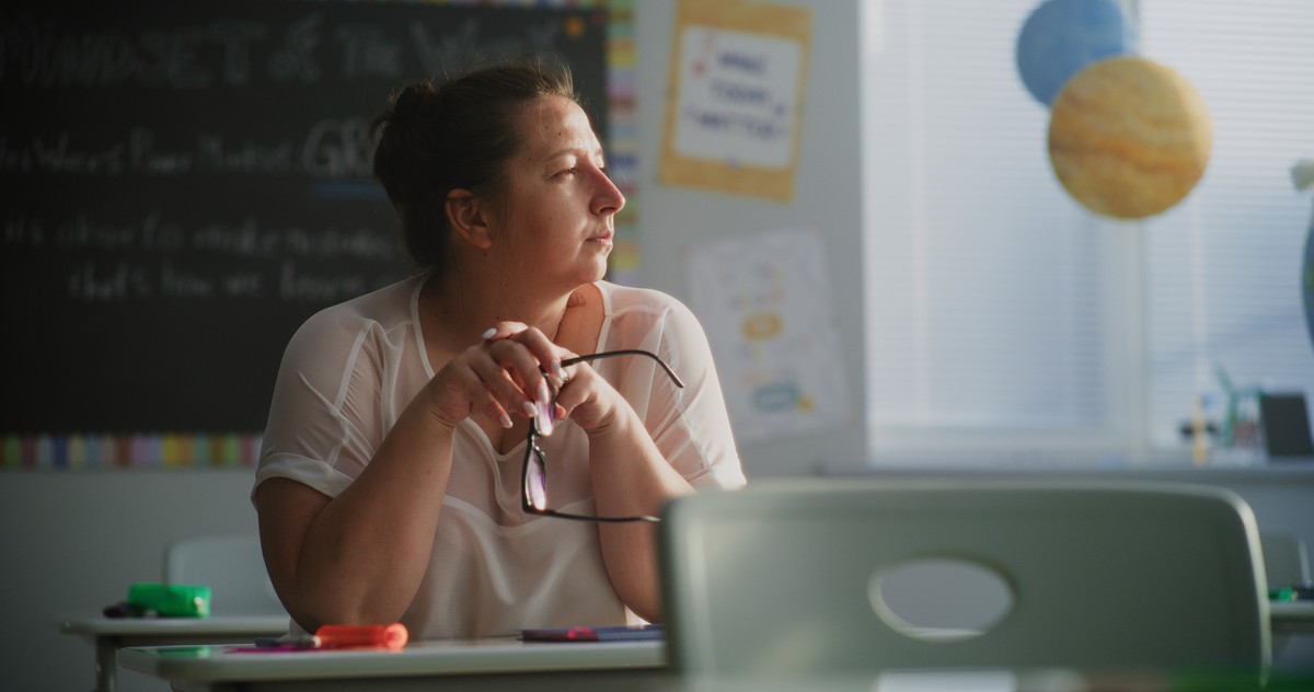 Tired,Female,Teacher,Sitting,Alone,At,The,Desk,In,Empty