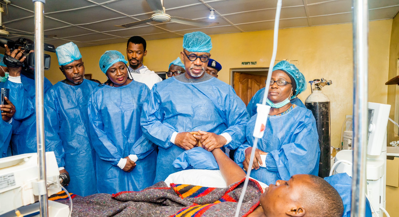 Gov. Dapo Abiodun holding the victim in Intensive Care Unit at Federal Medical Centre, Abeokuta. [Twitter:@dabiodunMFR