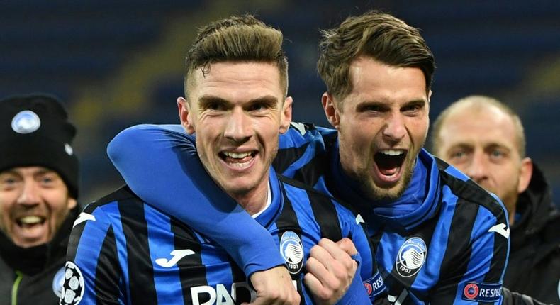 Atalanta defender Robin Gosens (L) celebrates with Hans Hateboer (R) as debutants Atalanta reached the Champions League last 16