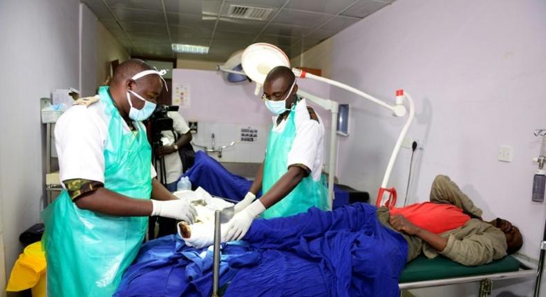 Kenyan Defence Force (KDF) doctors tend to an injured man at Kenyatta National Hospital in Nairobi on December 10, 2016, after being deployed during a five-day strike