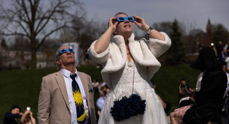 Lori Lycans and Tom Wissinger watch the eclipse at Elope at the Eclipse in Tiffin, Ohio, before getting married during totality.Maddie McGarvey/For The Washington Post via Getty Images
