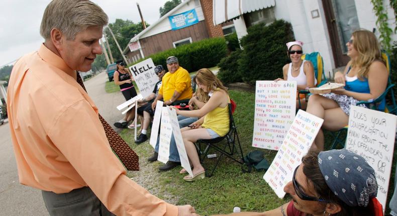 Pastor Bill Dunfee greets protesters outside his church in Warsaw, Ohio, on Sunday, Aug. 22, 2010.Jay LaPrete, File/Associated Press