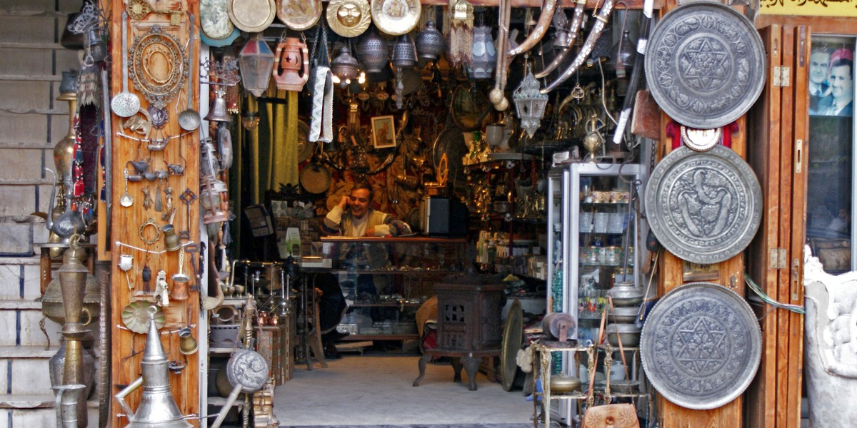 A vendor sits inside an antique shop in al-Jdeideh neighborhood, in the Old City of Aleppo, in 2009.