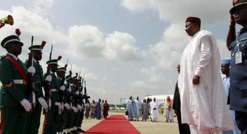 Nigers President Mahamadou Issoufou inspects the guard of honour upon arrival at the airport in Abuja, Nigeria May 28, 2015.