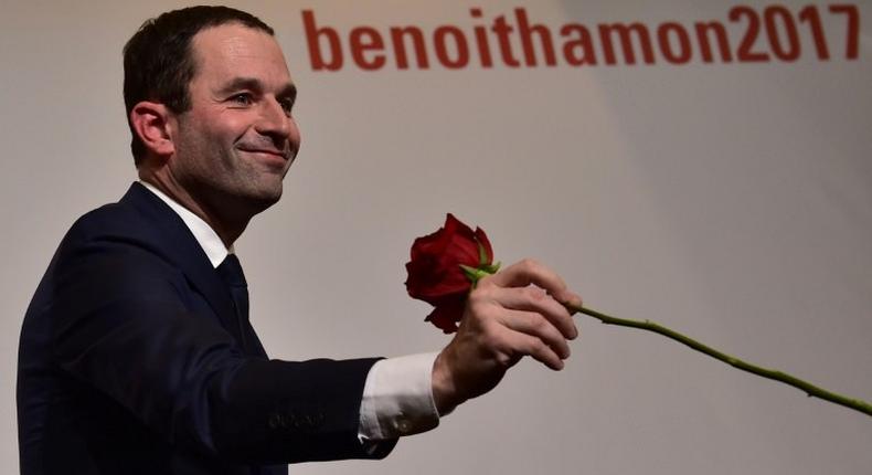 Benoit Hamon holds a rose following the first results of the primary's second round on January 29, 2017