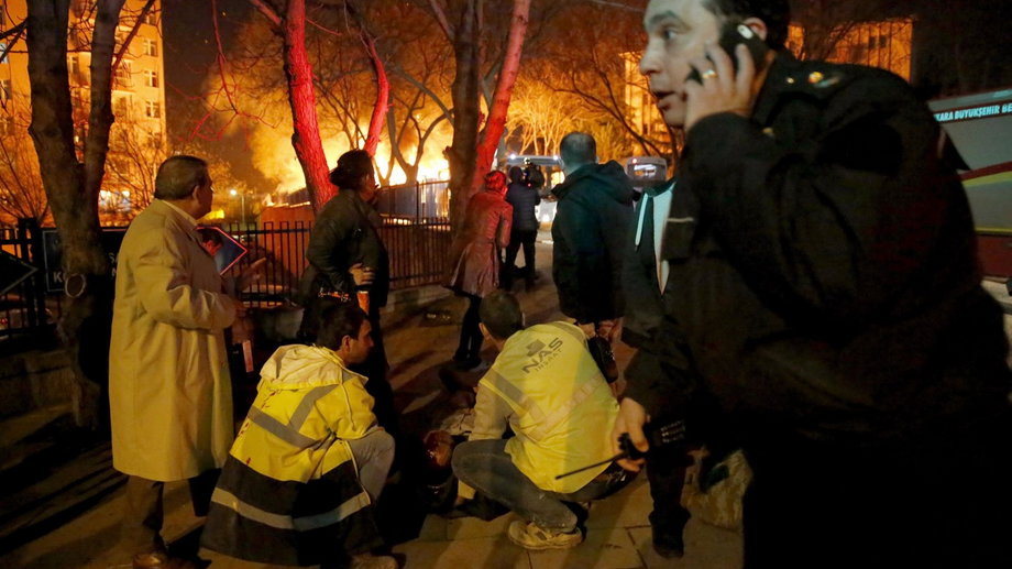 Emergency responders look toward the scene of a bombing in Ankara, Turkey, on February 17.