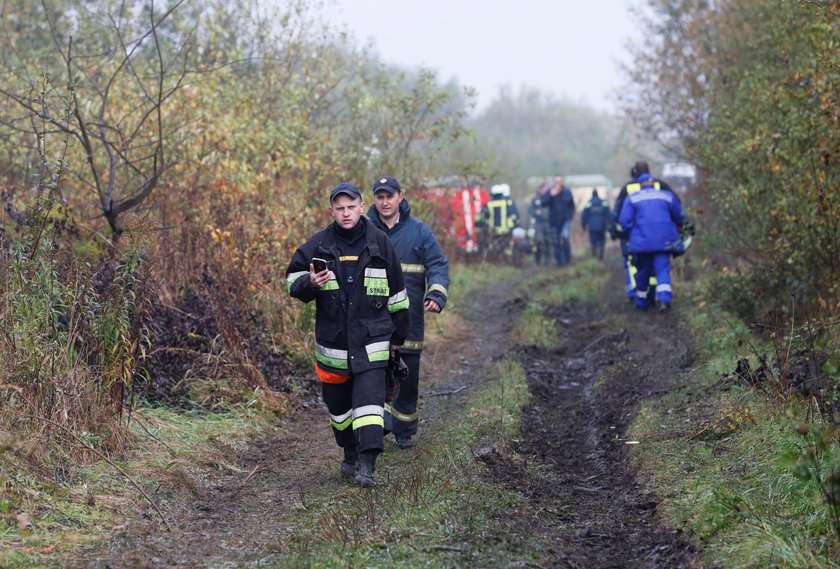 Medics assist a wounded person at the site of the Antonov-12 cargo airplane emergency landing in Lvi