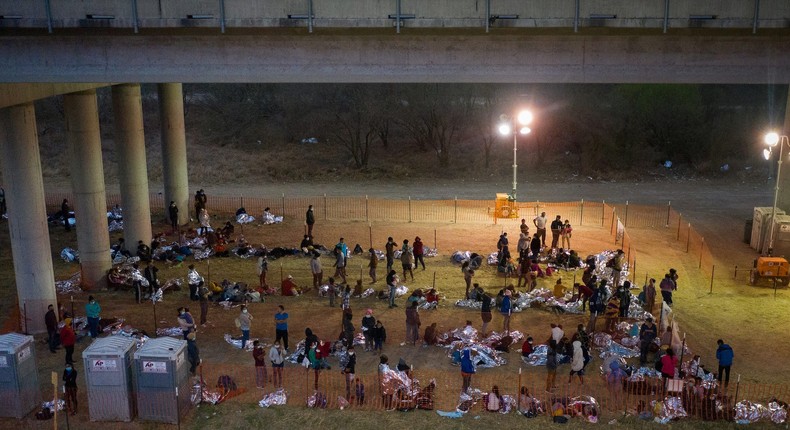 Asylum seeking migrant families and unaccompanied minors from Central America take refuge in a makeshift U.S. Customs and Border Protection processing center under the Anzalduas International Bridge after crossing the Rio Grande river into the United States from Mexico in Granjeno, Texas, U.S., March 12, 2021
