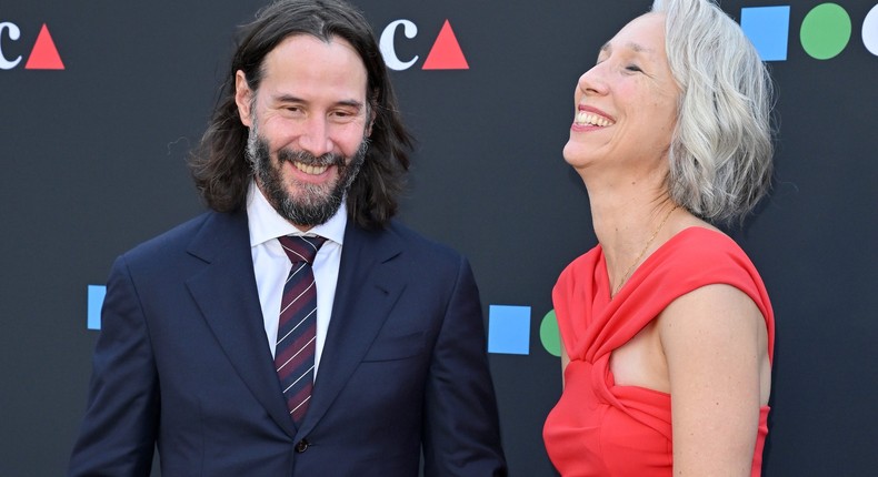 Keanu Reeves and girlfriend Alexandra Grant hold hands while walking the red carpet together.Axelle/Bauer-Griffin/FilmMagic