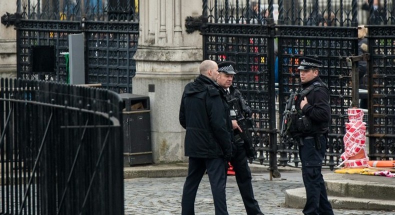 Armed police stand guard at the entrance to the Houses of Parliament which remain closed in central London on March 24, 2017 two days after the March 22 terror attack on the British parliament and Westminster Bridge