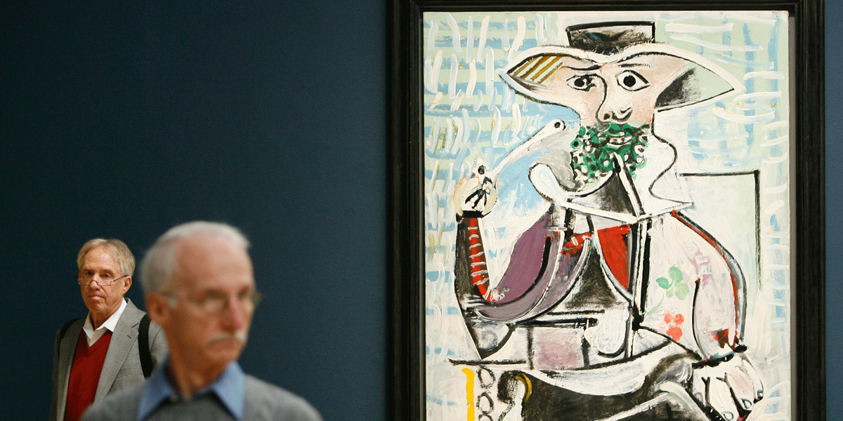 Two men walk past Pablo Picasso's "Homme a la Pipe," 1969 which is to be sold at Sotheby's upcoming sale of Impressionist and Modern Art in New York.