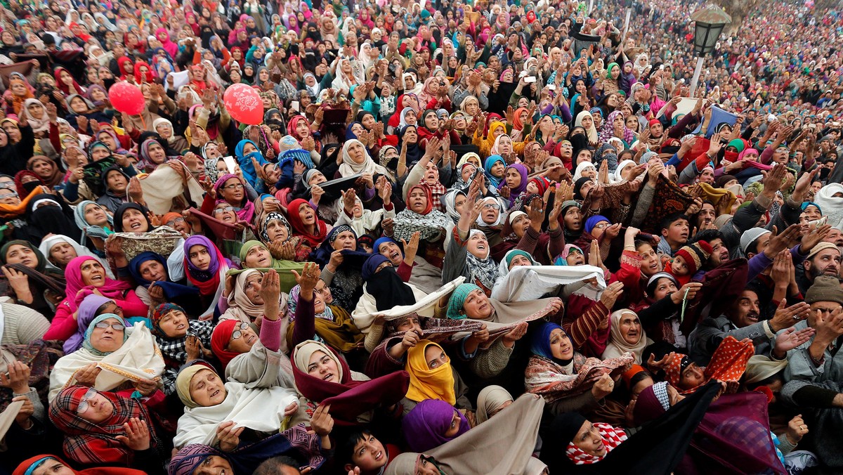 Kashmiri Muslims react upon seeing a relic believed to be a hair from the beard of Prophet Mohammed, being displayed on the Friday following the festival of Eid-e-Milad-ul-Nabi, the birthday anniversary of the prophet, at the Hazratbal shrine in Srinagar