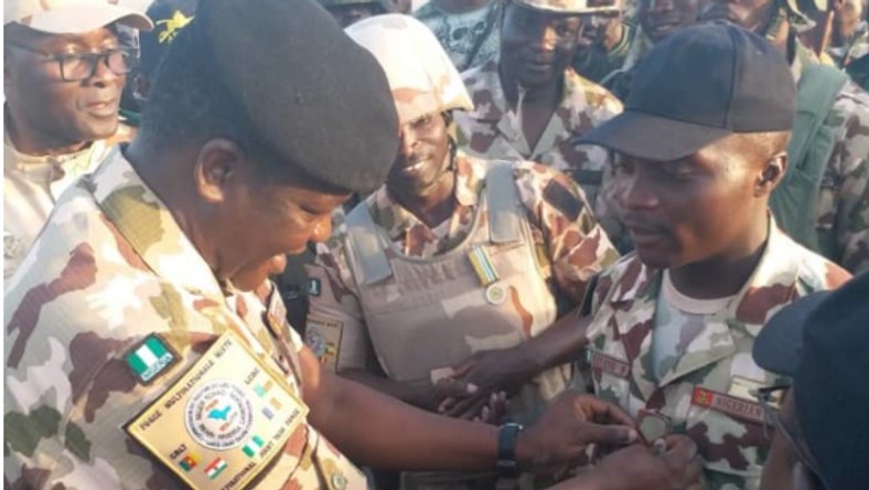  Private Illyasu Bala surrounded by colleagues while being decorated by one of the senior officers. (NAN)