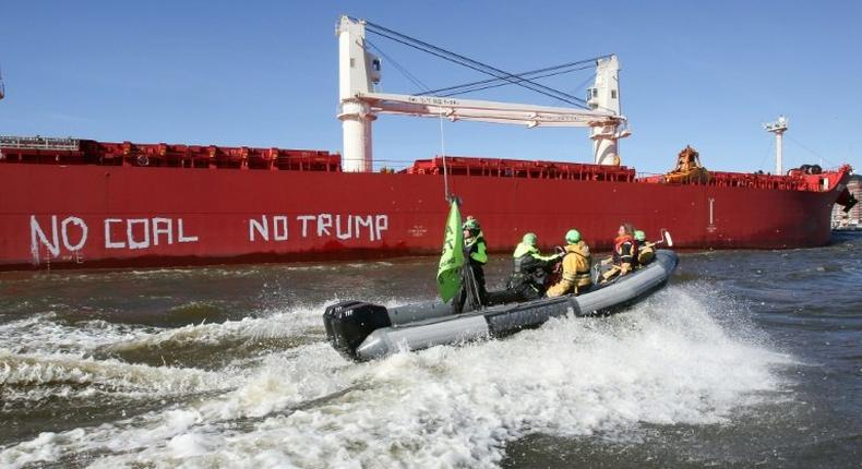 Activists of Greenpeace have painted 'No Coal No Trump' on the side of the 'SBI Subaru' ship with some 60,000 tons of coal from Texas on board in Hamburg, nothern Germany on June 1, 2017