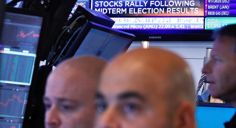 Traders work in a booth on the floor of the New York Stock Exchange, Wednesday, Nov. 7, 2018. Technology and health care stocks are leading indexes broadly higher on Wall Street as results of the midterm elections came in largely as investors had expected.