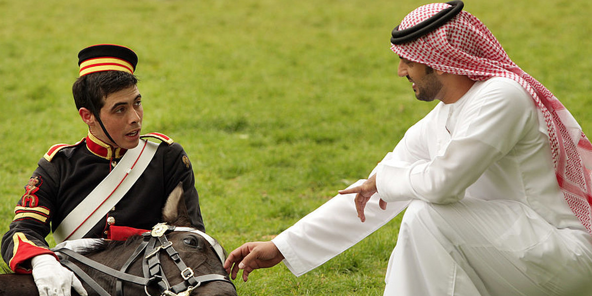Lance Corporal Daniel Evans of the Household Cavalry Mounted Regiment, sits with his lie-down horse, Beatrice, as he is inspected by Talal Al Hashimi of the Abu Dhabi Sports Council in Hyde Park on May 14, 2009 in London, England.