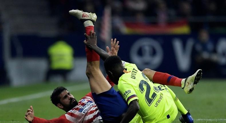 Atletico Madrid forward Diego Costa in a tangle with Barcelona's Samuel Umtiti