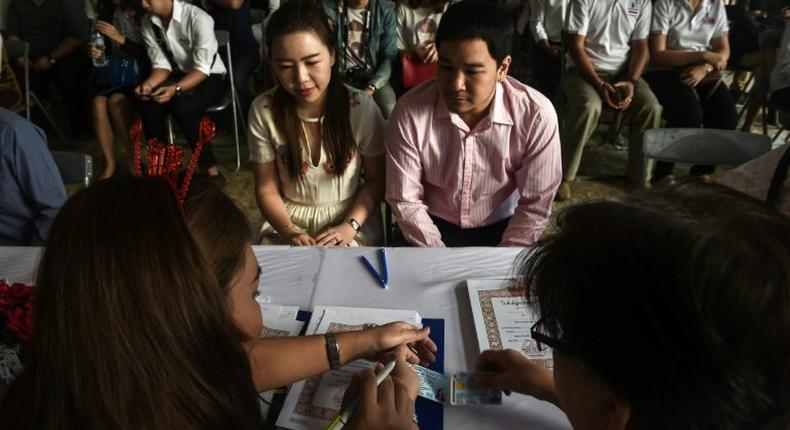 A couple registers their marriage on Valentine's Day at the central post office in Bang Rak, or Love Village, district in Bangkok on February 14, 2017