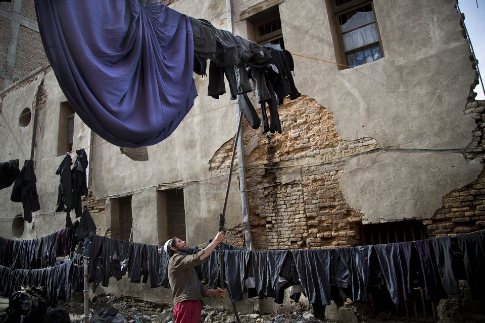 Afgańczyk suszy świeżo ufarbowane burki. Kabul, 2013 r.